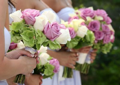 row of bridesmaids holding bouquets at wedding ceremony